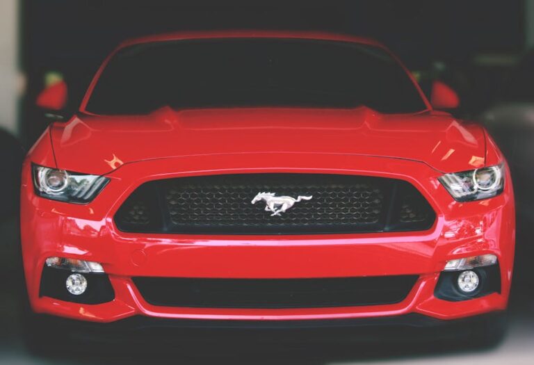 Bright red Ford Mustang showcased with a sleek front view in Ahmedabad.