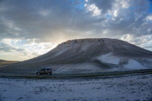 A scenic view of a car driving at sunset near a mountainous terrain in Eskişehir, Turkey.