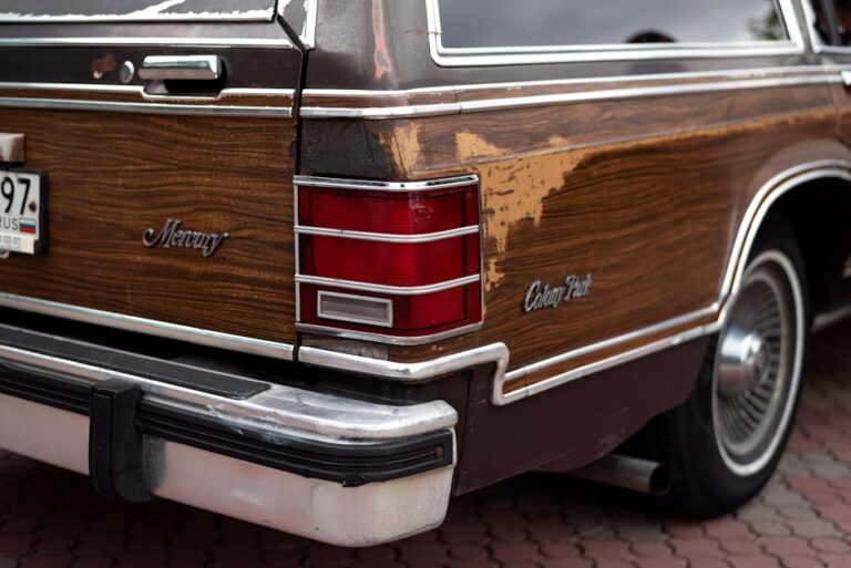 Close-up of an antique Mercury Colony Park wagon's rear with wood paneling and tail light.
