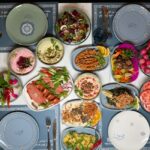 A colorful spread of Middle Eastern dishes including hummus, salads, and grilled vegetables, perfect for a festive gathering.