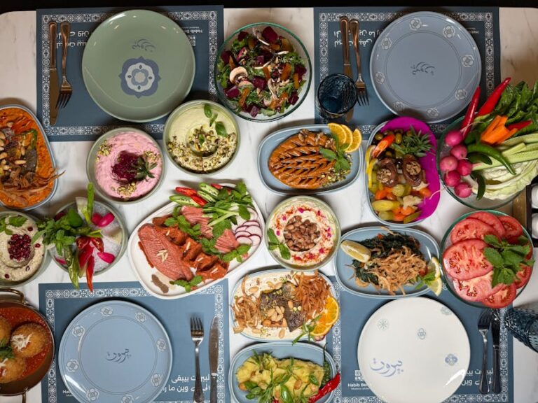 A colorful spread of Middle Eastern dishes including hummus, salads, and grilled vegetables, perfect for a festive gathering.