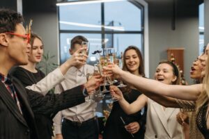 A joyful group toasting with champagne at a festive indoor celebration.