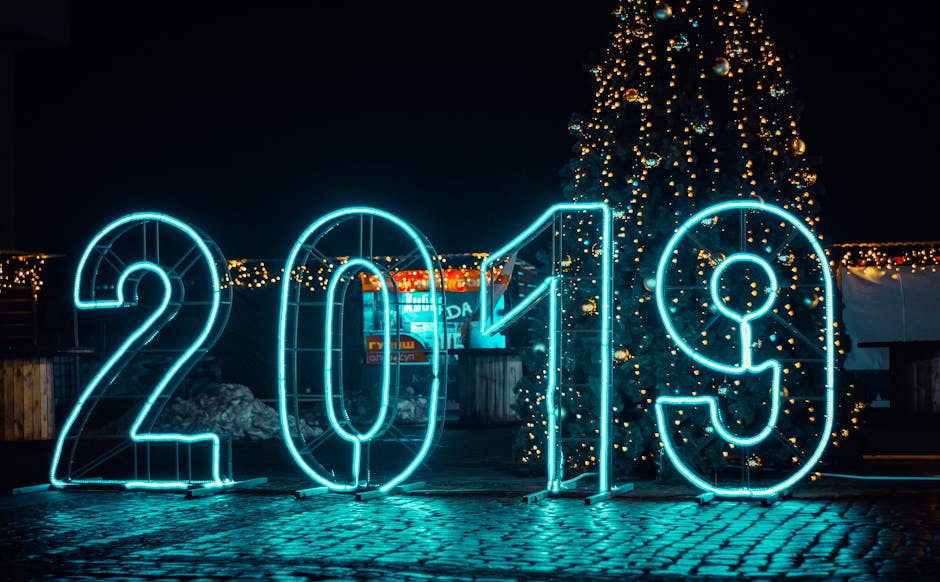 Bright neon '2019' sign with Christmas tree, perfect for New Year's festivities.